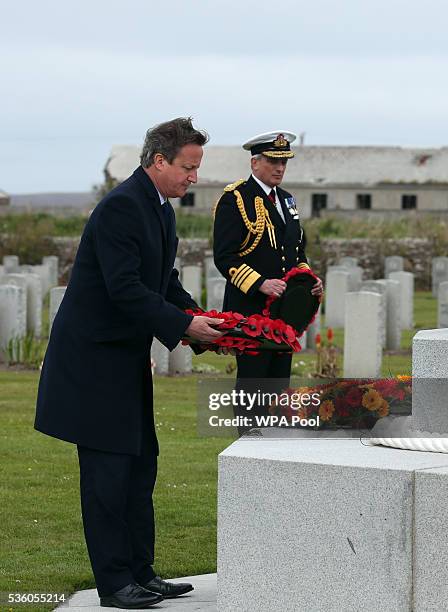 British Prime Minister David Cameron lays a wreath as Admiral Sir Philip Jones looks on at the Lyness cemetery during the 100th anniversary...