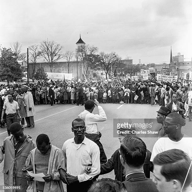Elevated view of a marchers at the culmination of the Selma to Montgomery March, Montgomery, Alabama, March 25, 1965. At far left fore is American...