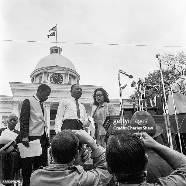 View of American religious and Civil Rights leaders John Lewis and Martin Luther King Jr and his wife, Coretta Scott King , on the podium before the...