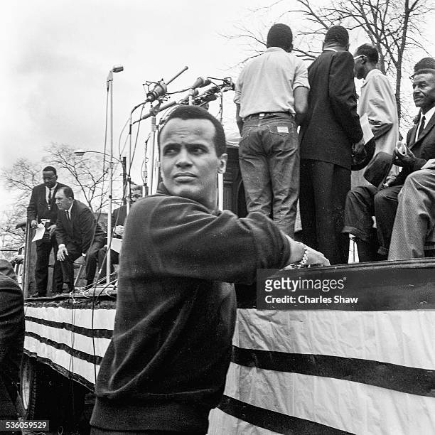 At the end of the Selma to Montgomery March, American singer and activist Harry Belafonte leans on a podium in front of the Alabama State Capitol,...