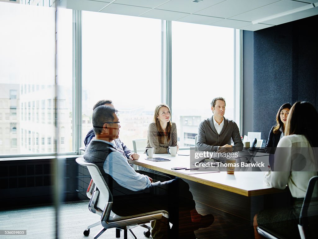 Coworkers in morning meeting in conference room