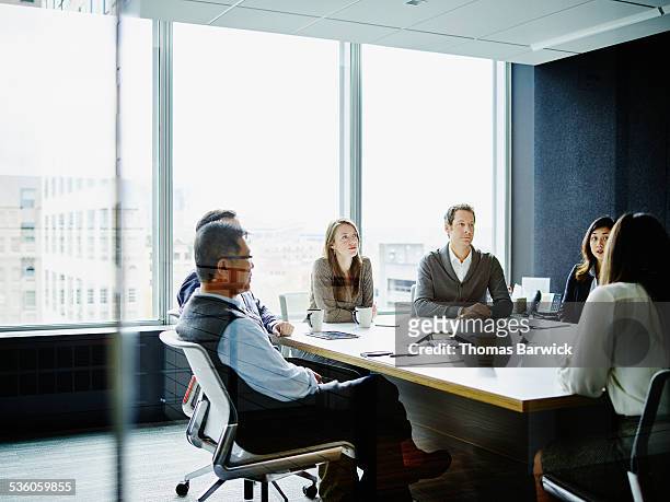 coworkers in morning meeting in conference room - group people thinking stock pictures, royalty-free photos & images
