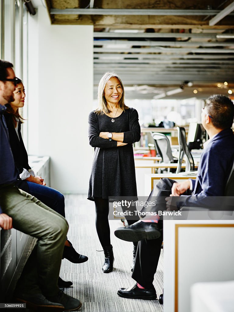 Mature businesswoman leading team meeting