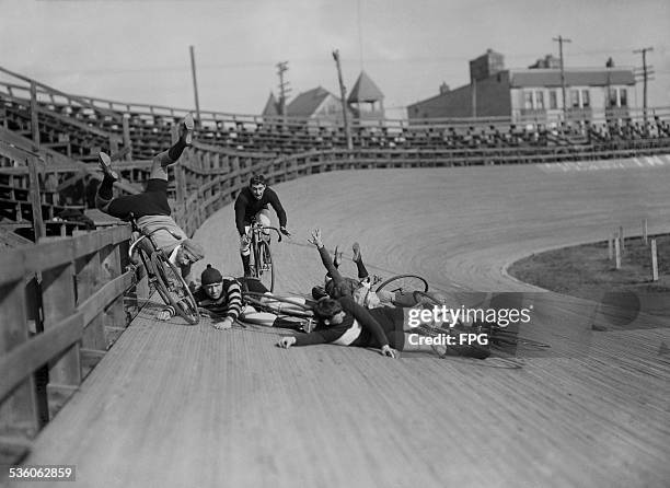 Group of track cyclists set up a humourous tableau of an 'accident', 1910.
