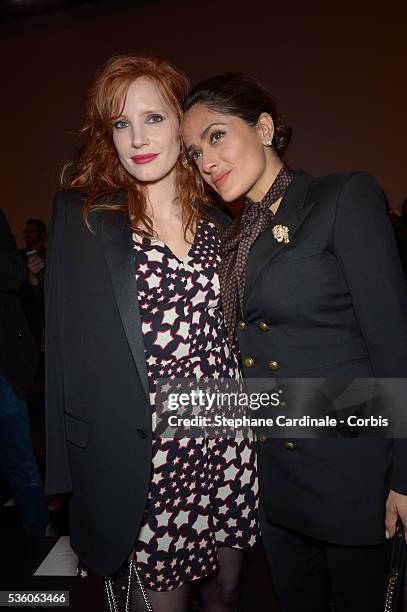 Jessica Chastain and Salma Hayek attend the Saint Laurent show as part of the Paris Fashion Week Womenswear Fall/Winter 2015/2016 on March 9, 2015 in...