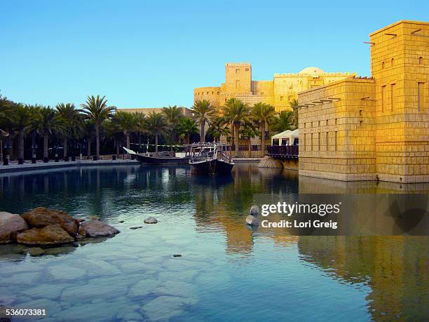 Dubai Creek reflects the Madinat Jumeirah Arabian Resort in Dubai, UAE