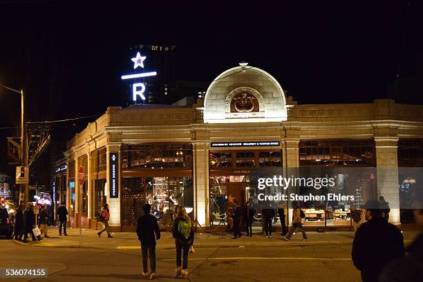 View of the Starbucks Reserve Roastery & Tasting Room storefront, retail sign, and glowing logo at the newest concept store in the Capitol Hill...