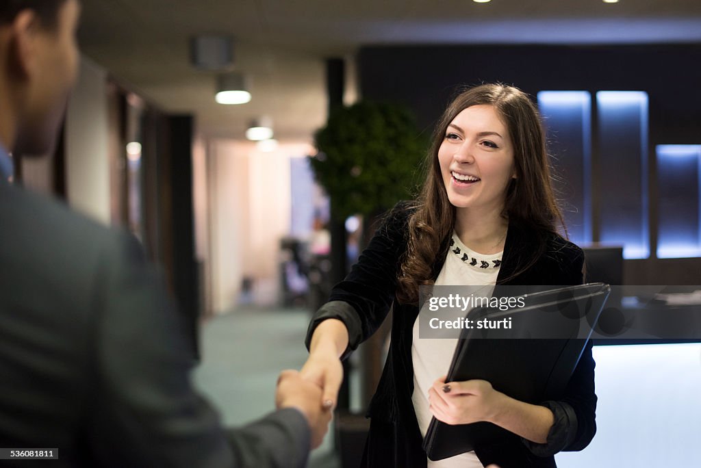 Young woman shakes hands with her potential new boss