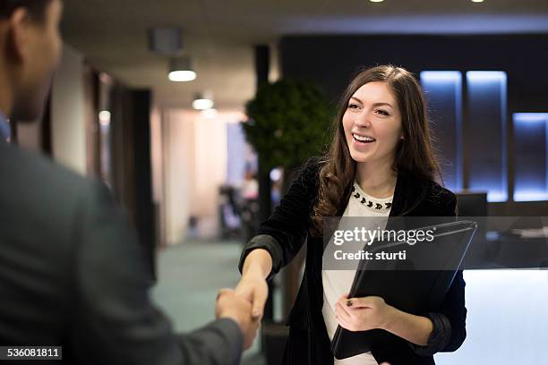 young woman shakes hands with her potential new boss - interview event 個照片及圖片檔