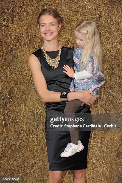 Natalia Vodianova with her daughter at "Chanel" ready-to-wear Spring/Summer 2010 collection during Paris Fashion Week.