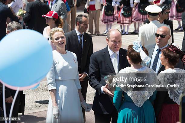 Princess Charlene of Monaco and Prince Albert II of Monaco greet people on the Monaco Palace square after the baptism of the Princely Children in...