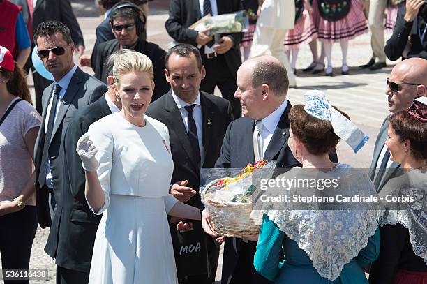 Princess Charlene of Monaco and Prince Albert II of Monaco greet people on the Monaco Palace square after the baptism of the Princely Children in...