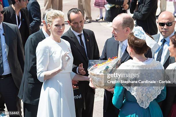 Princess Charlene of Monaco and Prince Albert II of Monaco greet people on the Monaco Palace square after the baptism of the Princely Children in...