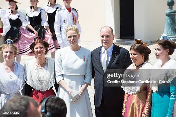 Princess Charlene of Monaco and Prince Albert II of Monaco pose with Monegasque people on the Monaco Palace square after the baptism of the Princely...