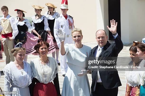 Princess Charlene of Monaco and Prince Albert II of Monaco pose with Monegasque people on the Monaco Palace square after the baptism of the Princely...