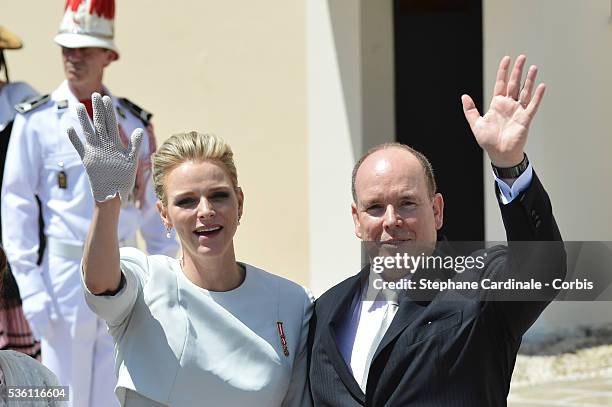 Princess Charlene of Monaco and Prince Albert II of Monaco wave to the crowd on the Monaco Palace square after the Baptism of twins Prince Jacques...