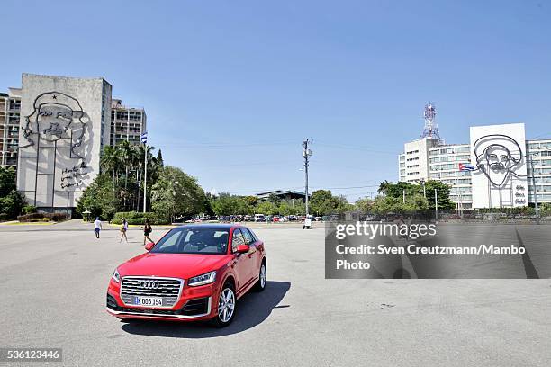 German carmaker Audis latest model, stands under the images of Cuban Revolution heroes Che Guevara and Camilo Cienfuegos at the Plaza de la...