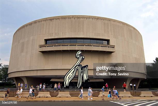 Pedestrians walk outside the Hirshhorn Museum and Sculpture Garden, the Smithsonian's museum of international modern and contemporary art.