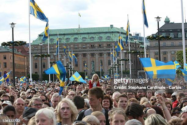 People wait for Crown Princess Victoria of Sweden, Duchess of Västergötland, and her husband Prince Daniel, Duke of Västergötland, to pass after...