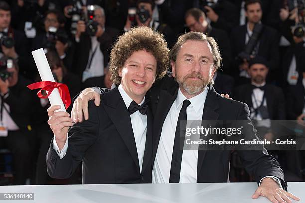 Director Michel Franco, winner of the Best Screenplay Prize for his film 'Chronic' poses with actor Tim Roth at a photocall for the winners of the...