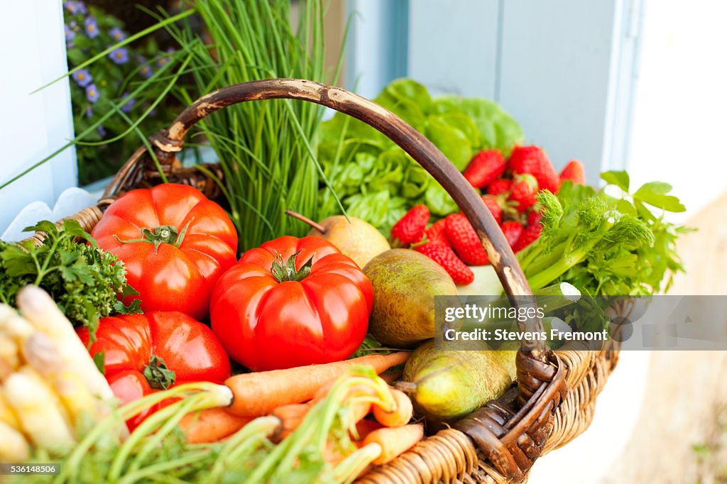 Basket full of fresh fruit and vegetables