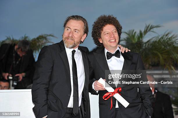 Director Michel Franco, winner of the Best Screenplay Prize for his film 'Chronic' poses with actor Tim Roth at a photocall for the winners of the...