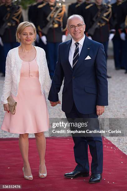 Minister of the Interior Bernard Cazeneuve and wife arrive at the State Dinner offered by French President François Hollande at the Elysee Palace on...