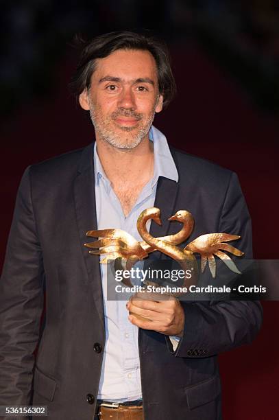 Emmanuel Mouret poses with his prize as he was awarded for Best movie during the closing Ceremony of the 29th Cabourg Romantic Film Festival on June...