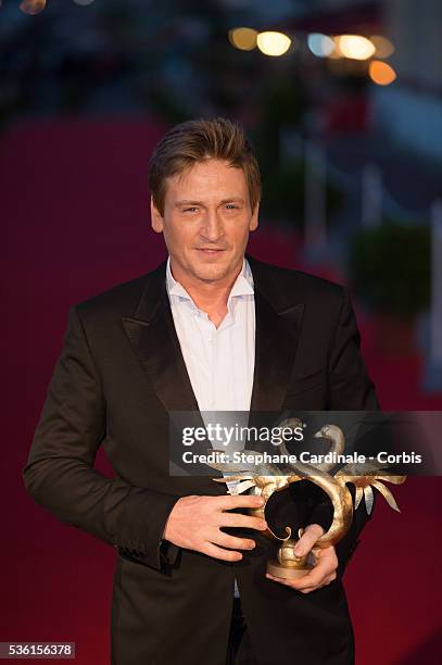Benoit Magimel poses with his prize as he awarded best actor during the closing Ceremony of the 29th Cabourg Romantic Film Festival on June 13, 2015...