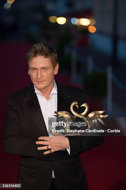 Benoit Magimel poses with his prize as he awarded best actor during the closing Ceremony of the 29th Cabourg Romantic Film Festival on June 13, 2015...