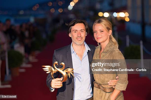 Emmanuel Mouret poses with Virginie Efira as he was awarded for Best movie during the closing Ceremony of the 29th Cabourg Romantic Film Festival on...