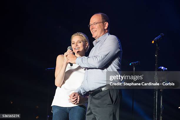 Prince Albert II of Monaco and Princess Charlene of Monaco speak onstage before the Robbie Williams concert during the Second Day of the 10th...