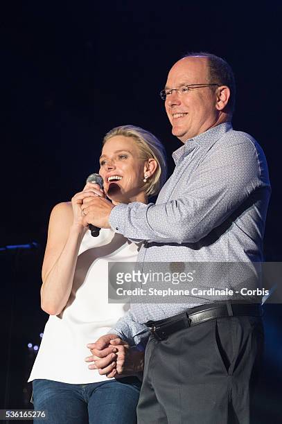 Prince Albert II of Monaco and Princess Charlene of Monaco speak onstage before the Robbie Williams concert during the Second Day of the 10th...