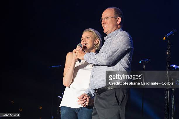 Prince Albert II of Monaco and Princess Charlene of Monaco speak onstage before the Robbie Williams concert during the Second Day of the 10th...