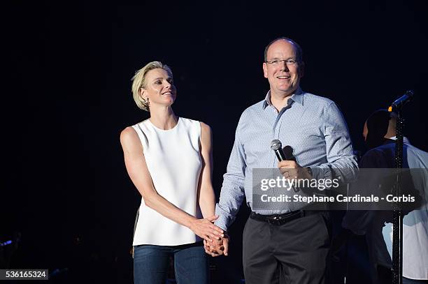 Prince Albert II of Monaco and Princess Charlene of Monaco speak onstage before the Robbie Williams concert during the Second Day of the 10th...