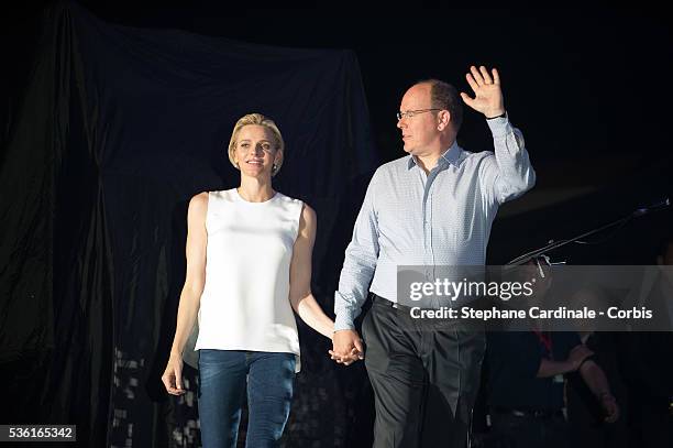 Prince Albert II of Monaco and Princess Charlene of Monaco speak onstage before the Robbie Williams concert during the Second Day of the 10th...