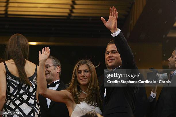 Actors Brad Pitt and Jennifer Aniston wave to the crowd before the premiere of Petersen's movie "Troy", at the 57th Cannes film festival.