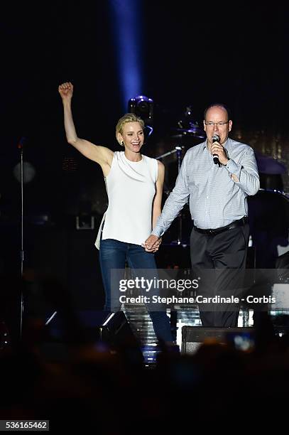 Prince Albert II of Monaco and Princess Charlene of Monaco speak onstage before the Robbie Williams concert during the Second Day of the 10th...