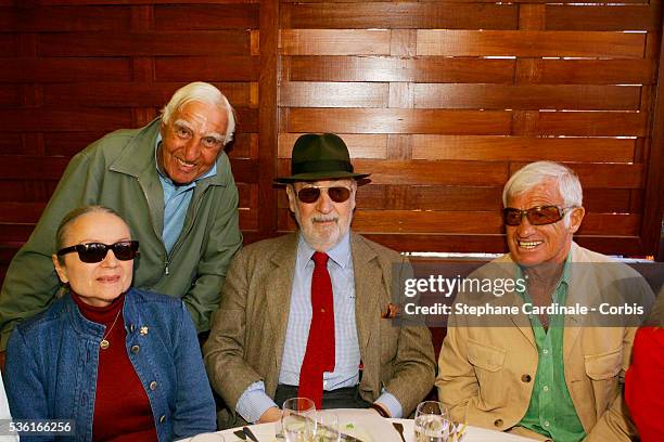 Charles Denner , Philippe Noiret and his wife and Jean-Paul Belmondo attend the Lacoste lunch during the Roland Garros French Open Tennis Tournament.