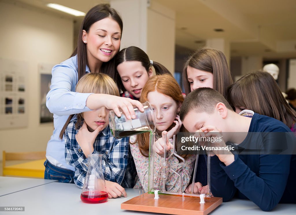 Children and teacher with chemistry experiments