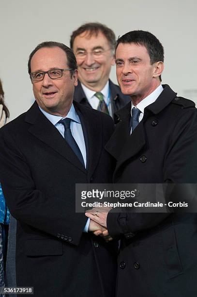 French President Francois Hollande shake hands with France's Prime Minister Manuel Valls during the COP21 United Nations Climate Change Conference on...