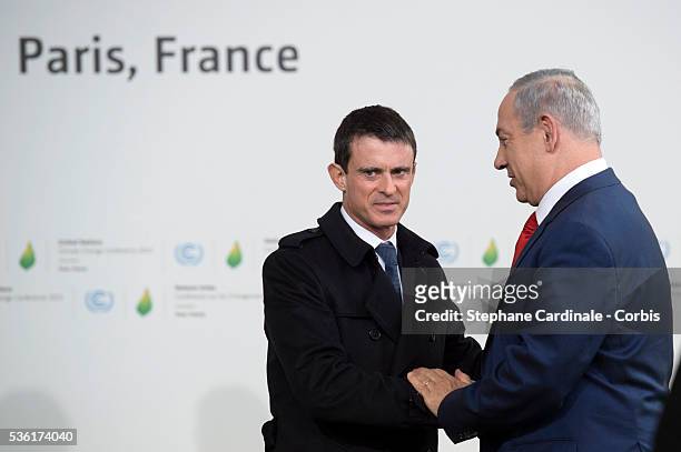 France's Prime Minister Manuel Valls greets Israeli Prime Minister Benjamin Netanyahu as he arrives for the COP21 United Nations Climate Change...