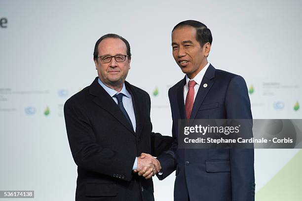 Indonesian President Joko Widodo shakes hands with French President Francois Hollande upon his arrival for the COP21 United Nations Climate Change...