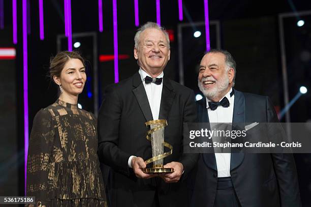 Bill Murray poses with his Tribute Award between Sofia Coppola and Francis Ford Coppola during the Opening Ceremony of the 15th Marrakech...