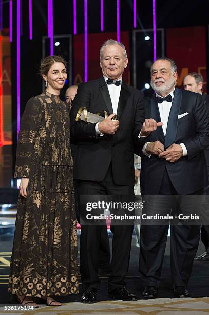 Bill Murray poses with his Tribute Award between Sofia Coppola and Francis Ford Coppola during the Opening Ceremony of the 15th Marrakech...