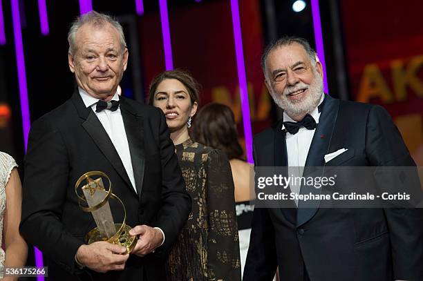 Bill Murray poses with his Tribute Award, with Sofia Coppola and Francis Ford Coppola during the Opening Ceremony of the 15th Marrakech International...