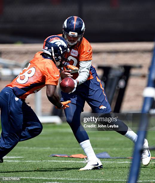 Denver Broncos quarterback Paxton Lynch hands off to Cyrus Gray during OTA's May 31, 2016 at UCHealth Training Facility, Dove Valley.