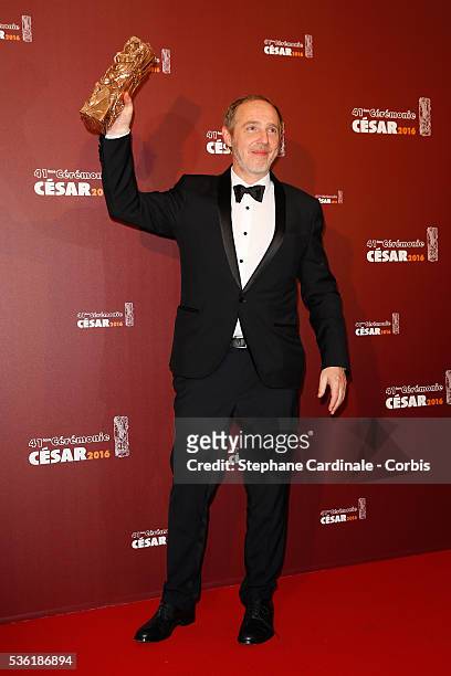 Arnaud Desplechin poses with his award of Best Drirector for the movie 'Trois souvenirs de ma jeunesse' during The Cesar Film Awards 2016 at Theatre...