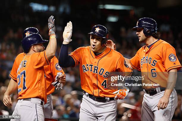 George Springer of the Houston Astros is congratulated by Jose Altuve, Jake Marisnick and Lance McCullers after Springer hit a three-run home run...