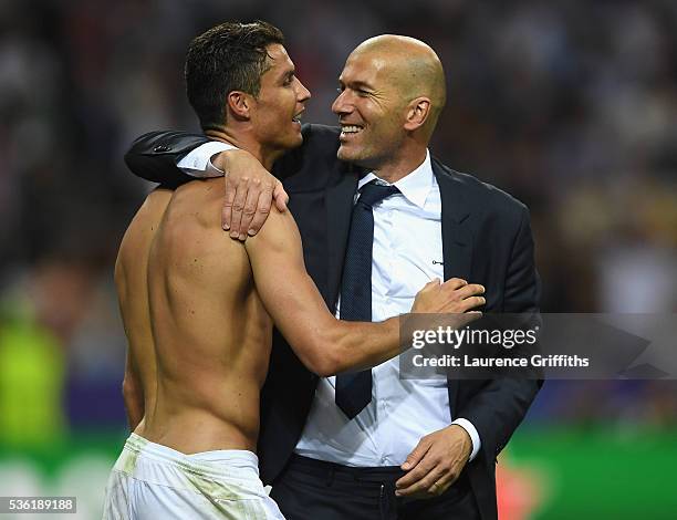 Cristiano Ronaldo of Real Madrid celebrates with head coach Zinedine Zidane after victory in the UEFA Champions League Final match between Real...